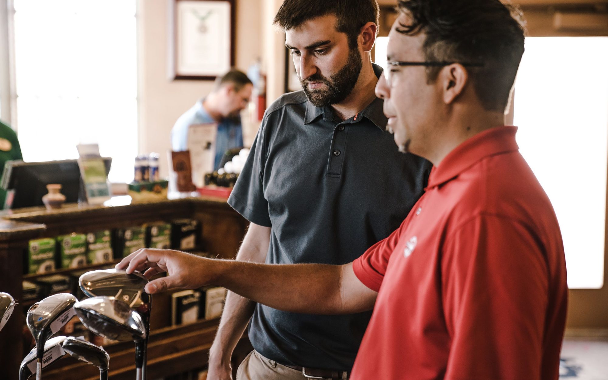 Golf instructor coaching a student on the range